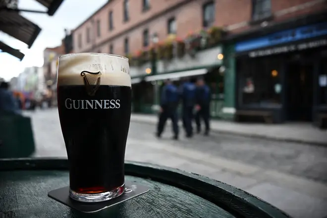 A pint of Guinness, is pictured on a table outside a pub