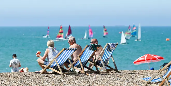 Brighton UK 11th August 2024 - Sunbathers and sailors enjoy the hot sunshine on Brighton beach