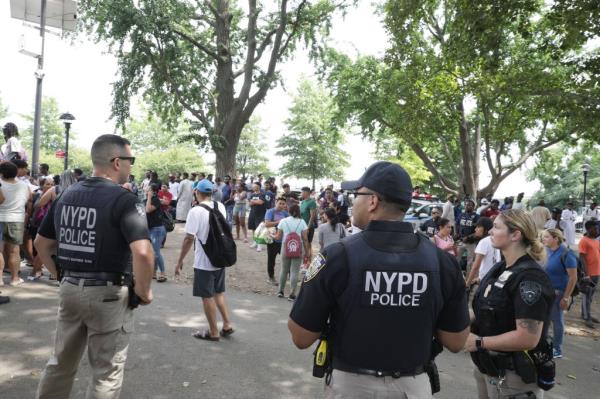 Cops outside the Randall's Island migrant shelter. 