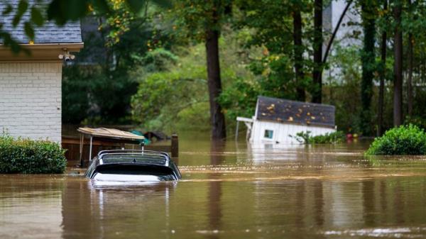 An vehicle, golf cart and playhouse are submerged from flooding Friday, Sept 27, 2024, in Atlanta. (AP Photo/Jason Allen)