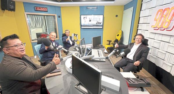 The Sirim visitors and Chan sitting in a radio booth at Menara Star. — SAMUEL ONG/The Star