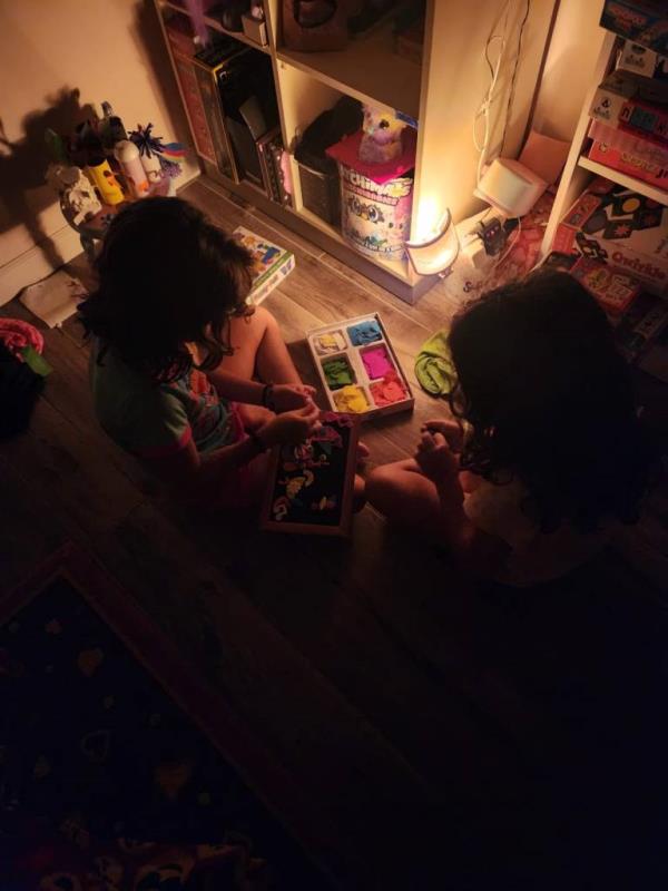 Two young girls sitting on the floor and playing