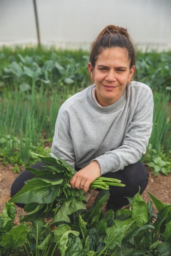 Michal Havivian holding picked plants