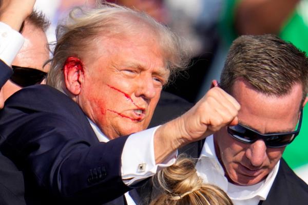 Republican presidential candidate former President Donald Trump reacts following an assassination attempt at a campaign event in Butler, Pa., on Saturday, July 13, 2024